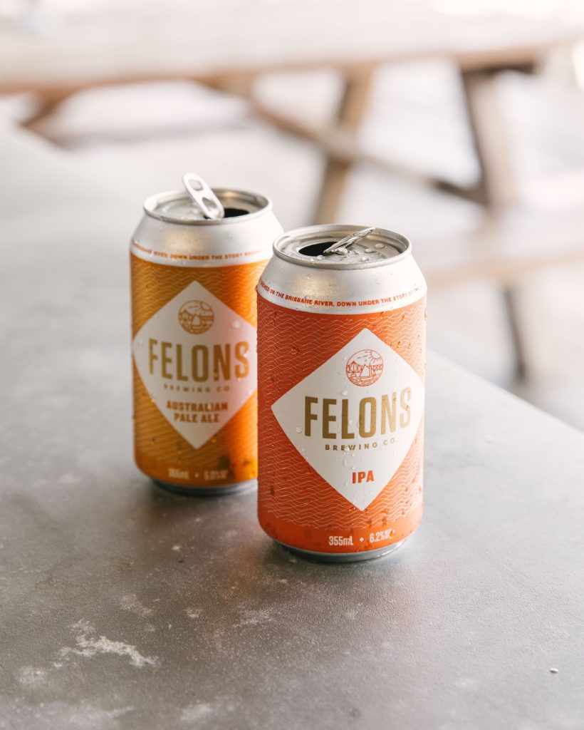 Two empty cans of Felons IPA